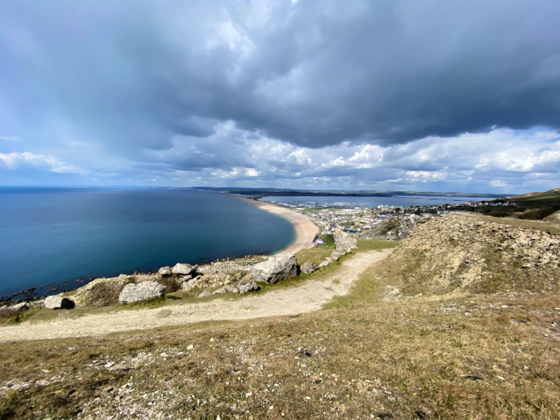 Chesil Beach. 21st August 2018. Two males enjoy swimming off Chesil Beach,  Portland, in Dorset, the