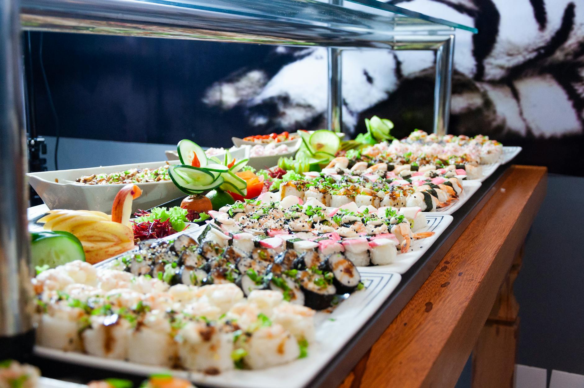 sushi on white plates on brown wooden table