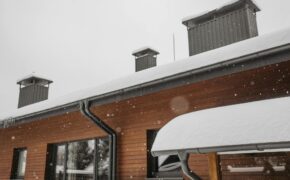 snow covered roof with chimneys