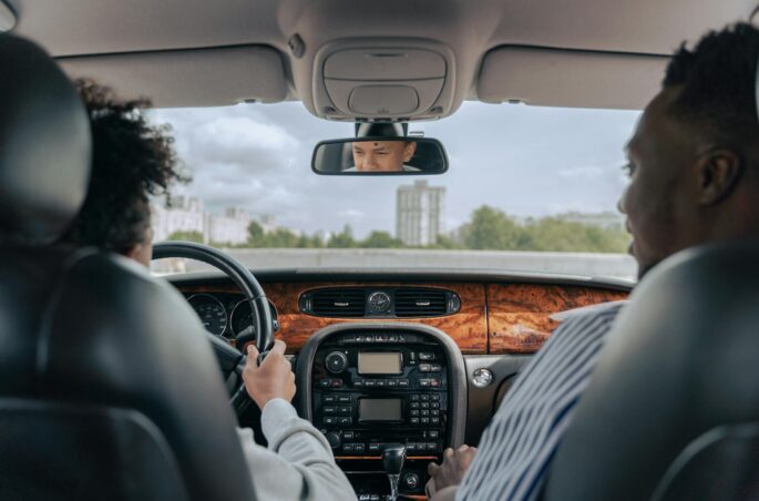 man in white long sleeve shirt driving car