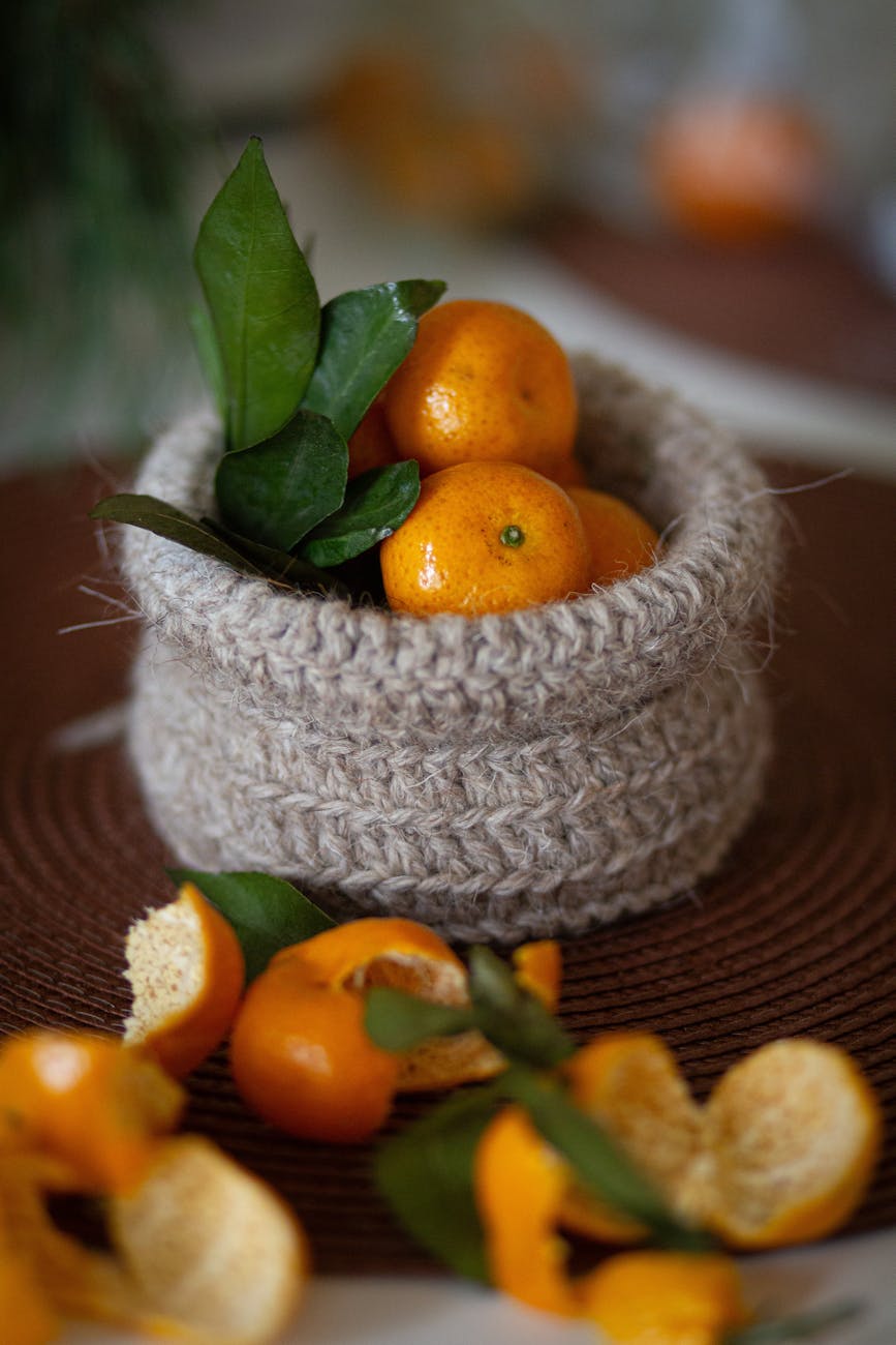 fresh oranges in rustic knitted basket close up