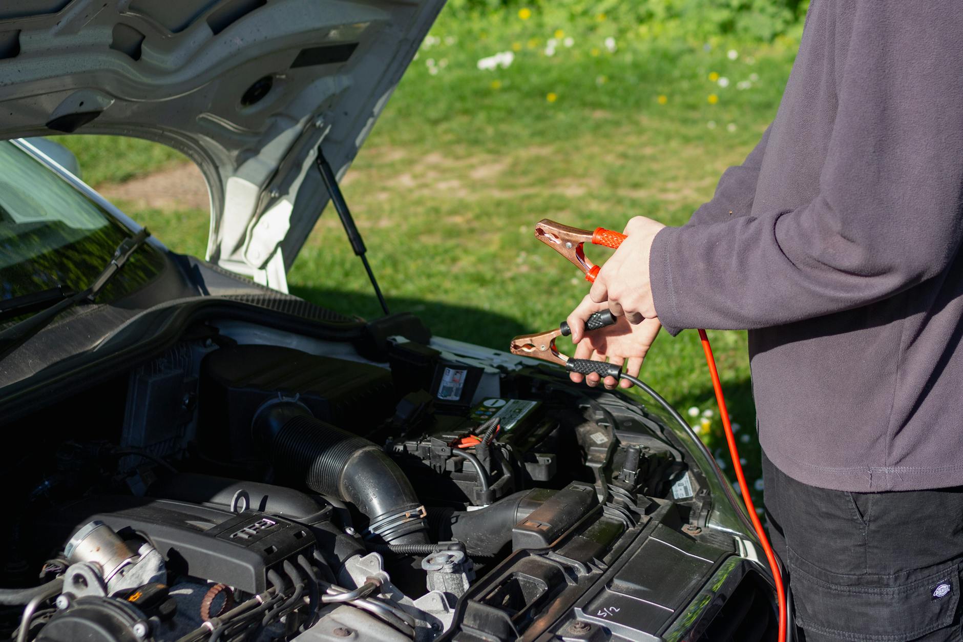 close up of man repairing car