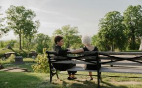 women sitting together at a bench
