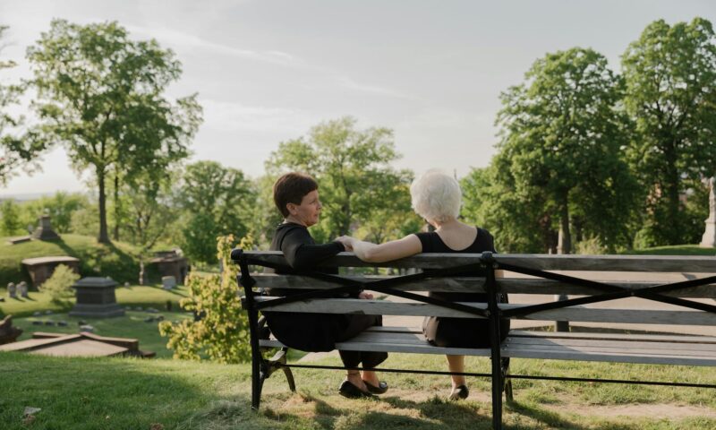 women sitting together at a bench