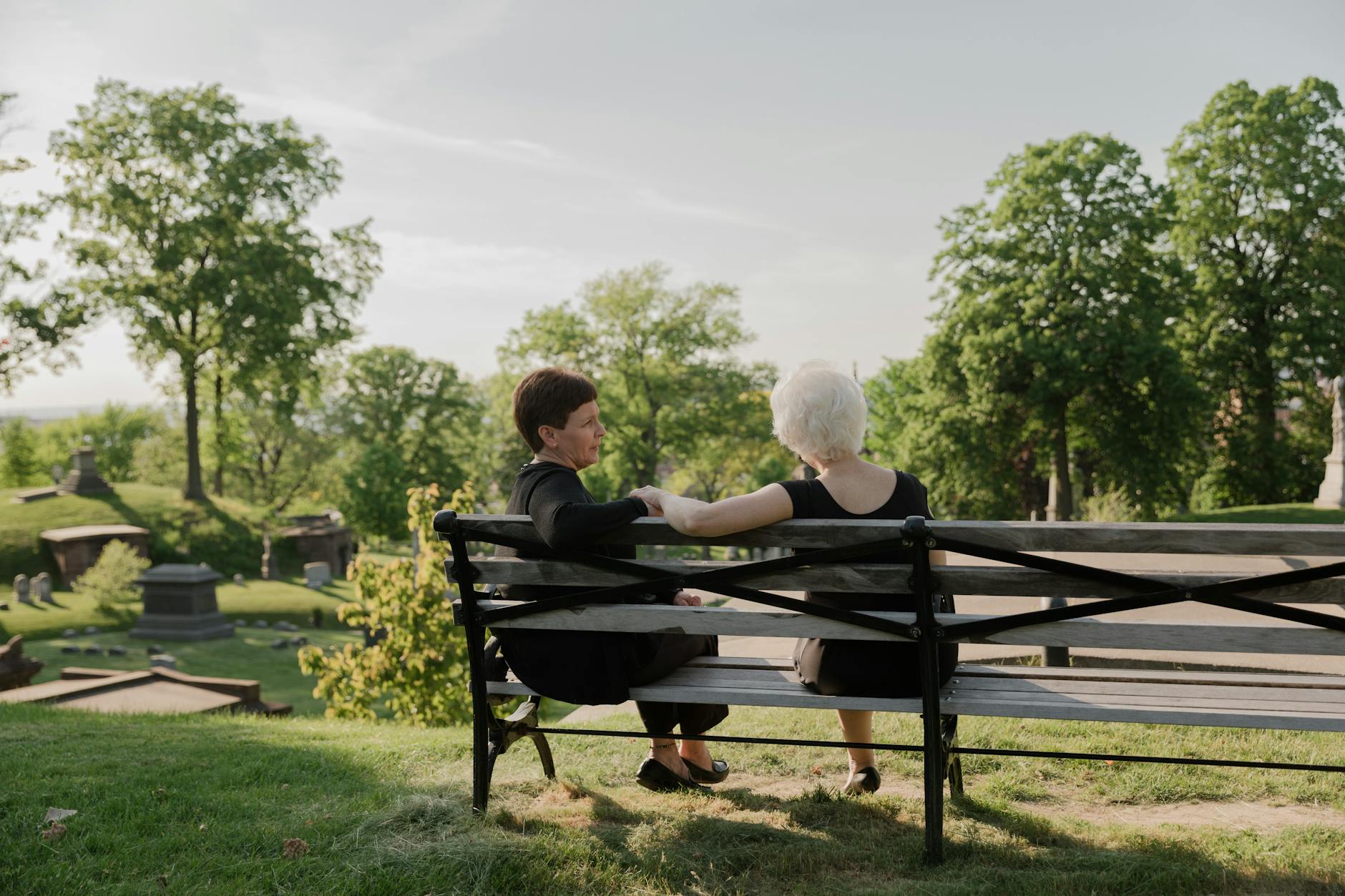women sitting together at a bench